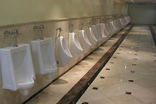 row of urinals in commercial bathroom