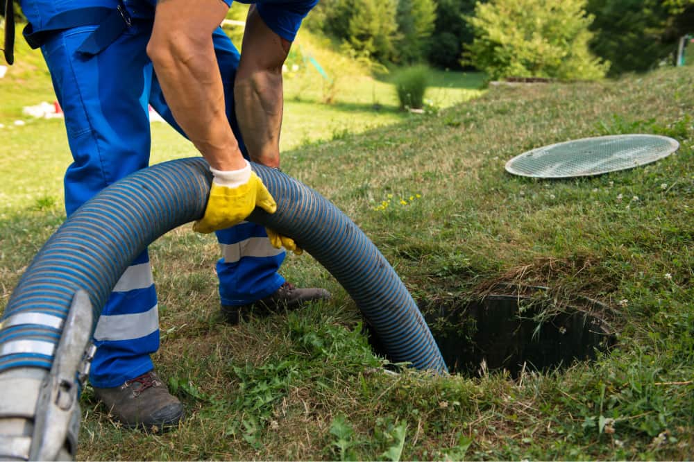 plumber performing sewer cleaning
